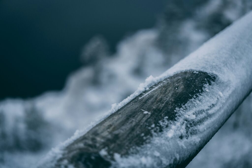 Exterior pipe covered in snow and ice during a cold snap